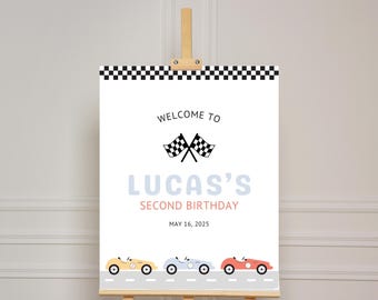 May include: Welcome to Lucas's Second Birthday party sign with a checkered border, a black and white checkered flag, and three cartoon race cars in yellow, blue, and red. The date May 16, 2025 is printed on the sign.