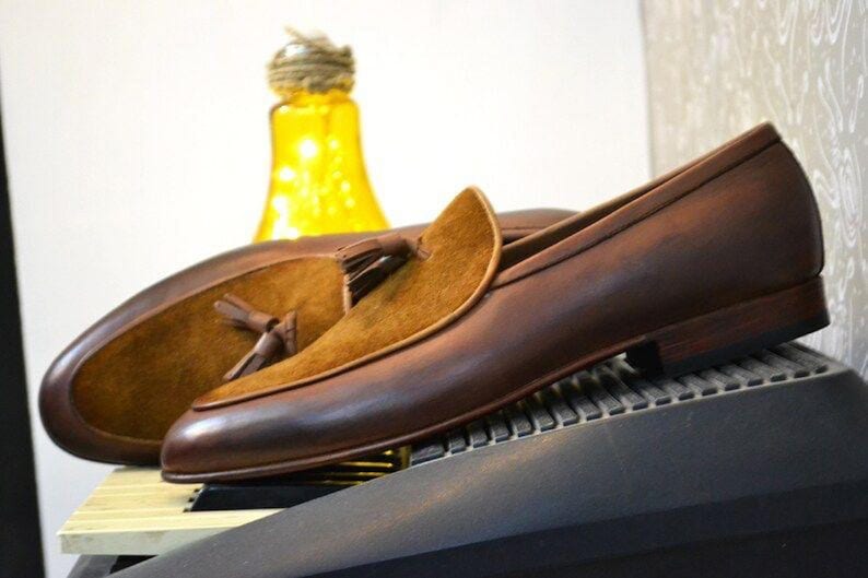 Peut inclure: Mocassins en cuir marron avec un d&eacute;tail en su&egrave;de &agrave; glands. Les mocassins ont une tige en cuir marron et un embout en su&egrave;de marron. Les mocassins sont sur une semelle en cuir marron.