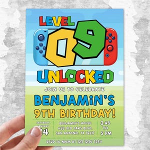 May include: A rectangular birthday invitation card featuring a blue and green background with a video game console graphic. The text reads LEVEL 09 UNLOCKED, JOIN US TO CELEBRATE BENJAMIN'S 9TH BIRTHDAY, along with event details including the date, time, and address.