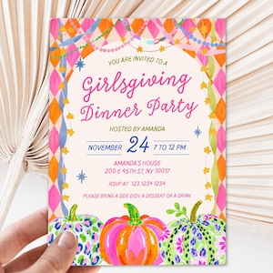 May include: A rectangular invitation card featuring a pink and orange diamond border, hanging garlands, and three pumpkins at the bottom. The text reads: You are invited to a Girlsgiving Dinner Party, hosted by Amanda, November 24, 7 to 12 PM.