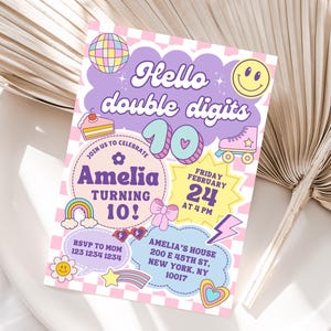 May include: A colorful birthday party invitation with the text "Hello double digits" and "Amelia turning 10!". The invitation features a disco ball, a smiley face, a cake, a rainbow, a roller skate, and other fun graphics. The invitation is on a pink and white checkered background.