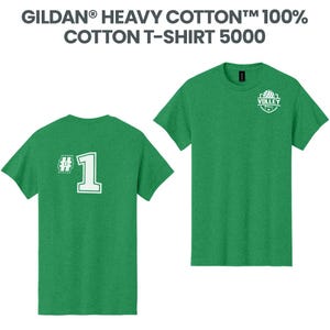 May include: Two green cotton t-shirts. One shirt has a white "#1" on the back. The other shirt has a volleyball logo on the front. The text "GILDAN HEAVY COTTON 100% COTTON T-SHIRT 5000" is at the top.