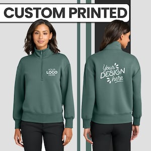 May include: A teal green quarter-zip sweatshirt with the text "CUSTOM PRINTED" at the top. The front of the sweatshirt has the text "YOUR LOGO HERE" and the back has the text "Your DESIGN here".