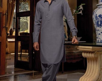 May include: A gray long-sleeved shirt with a button-up collar and matching pants. The man is wearing black shoes and sunglasses.