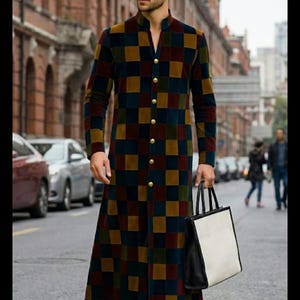 May include: A long, checkered coat in shades of navy, brown, and gold, featuring a mandarin collar and gold buttons. The coat is worn with black boots and a black and white tote bag. The background shows a city street with cars and pedestrians.