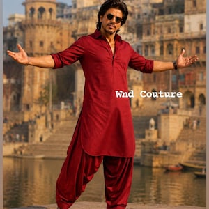 May include: A maroon kurta and salwar suit with the text "Wnd Couture". The outfit is worn by a person with sunglasses, standing in front of a body of water and buildings.