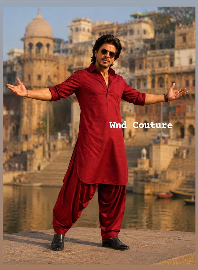 May include: A maroon kurta and salwar suit with the text "Wnd Couture". The outfit is worn by a person with sunglasses, standing in front of a body of water and buildings.
