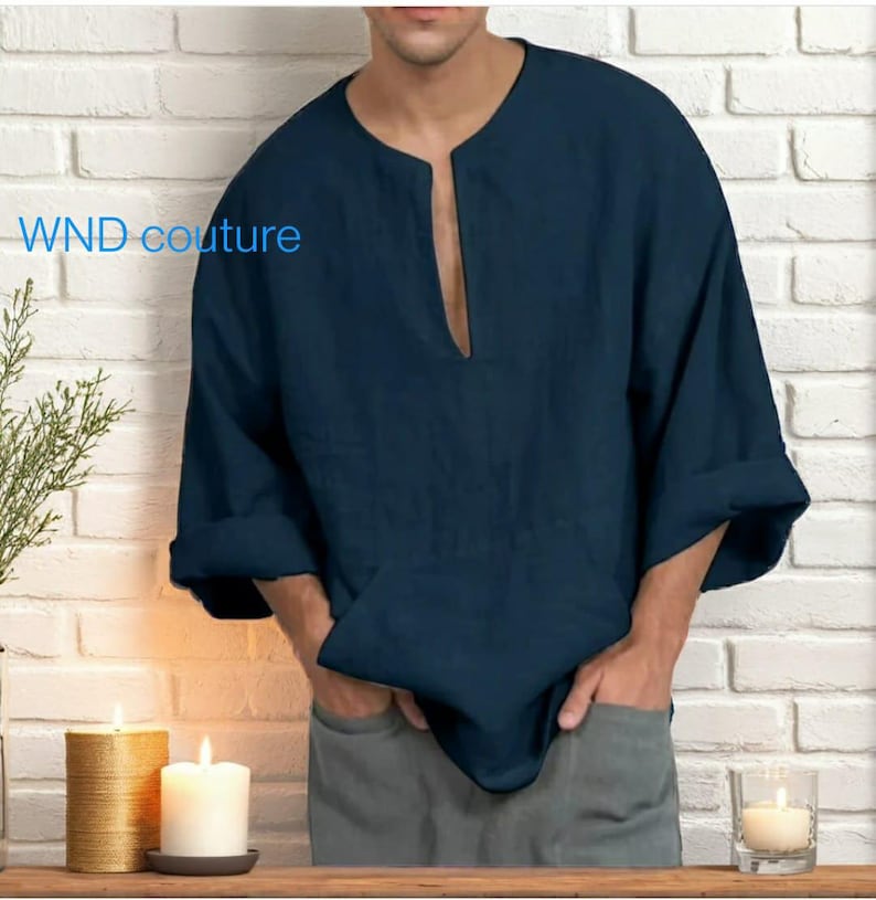 May include: A navy blue linen shirt with a wide, open neckline and three-quarter sleeves. The shirt has a relaxed fit and is visible from the chest down. The text "WND couture" is printed on the left side of the shirt.