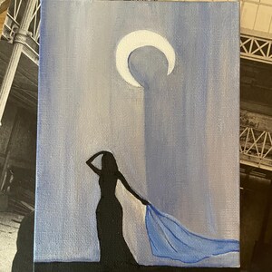 May include: A painting of a woman in a long black dress with a blue scarf flowing behind her. The woman is silhouetted against a light blue background with a white crescent moon in the upper right corner.