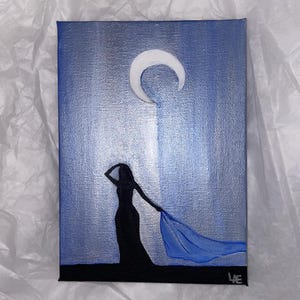 May include: A painting of a woman in a long dress with a flowing blue scarf, standing in front of a crescent moon against a blue and silver background.