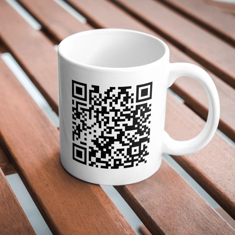 May include: White ceramic mug with a black and white QR code printed on the front.
