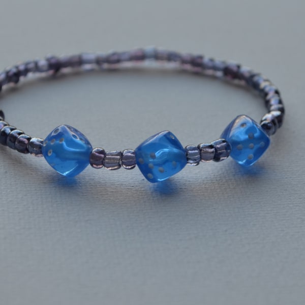 Bunco bracelet, purple glass seed beads with 3 blue dice, stretch bracelet