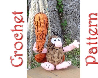 May include: Crocheted amigurumi toy of a cartoon caveman with a club. The caveman is brown with black hair and a pink nose. The club is orange and brown.