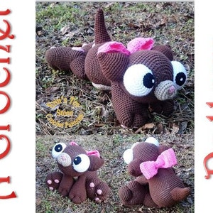 May include: Crochet pattern for a brown cat with large eyes and a pink bow. The cat is sitting on a bed of green grass.