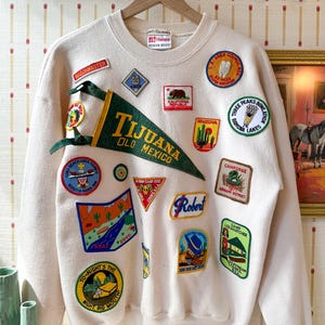 May include: A handmade wooden sign with the text "Welcome" in a playful font. The sign features a distressed finish and a simple, rustic design, perfect for a front door or entryway.