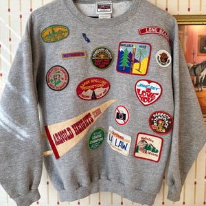 May include: A set of three ceramic mugs with a speckled, matte finish. The mugs are in shades of cream, light gray, and dark gray. Each mug has a simple, minimalist design, perfect for coffee or tea.