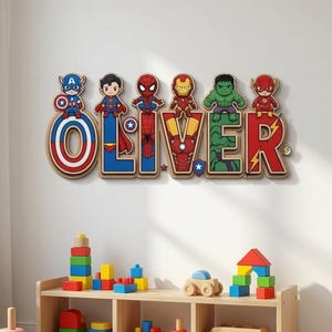 May include: A wall-mounted wooden sign spelling the name OLIVER, where each letter features a colorful cartoon superhero character design including Captain America, Superman, Spider-Man, Iron Man, the Hulk, and the Flash in a vibrant style.