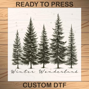 May include: A black and white illustration of five evergreen trees on a white background with the words "Winter Wonderland" below. The words "READY TO PRESS" and "CUSTOM DTF" are at the top and bottom.