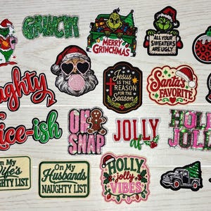 May include: A collection of embroidered Christmas-themed patches featuring various designs including the Grinch, Santa Claus, gingerbread men, holiday trucks, and text-based phrases like Naughty, Nice-ish, and Holly Jolly in red, green, and glittery finishes.