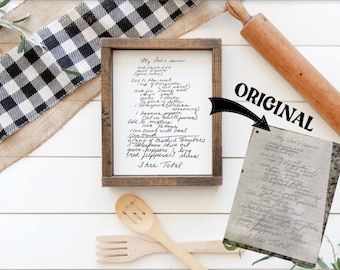 May include: A framed handwritten recipe for "My Dad's Sauce" on a white background. The recipe includes ingredients like ground meat, banana peppers, crushed tomatoes, and green peppers. The recipe is framed in a rustic wooden frame.