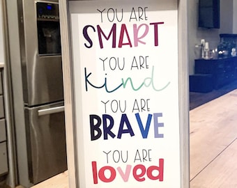 May include: A framed sign with the text "You are smart, You are kind, You are brave, You are loved" in colorful letters.