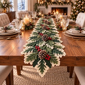 May include: A long, rectangular crochet table runner featuring a festive design of dark green pine branches, cream-coloured edges, and clusters of bright red berries. The runner is decorated with several brown pinecones throughout.
