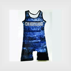 May include: Blue and black wrestling singlet with a white "DINEROBE" logo on the front. The singlet has a stone-like pattern.
