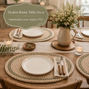 May include: A dining table setting featuring round, crocheted placemats in beige and sage green, white ceramic plates, linen napkins with fern prints, a ceramic pitcher filled with white flowers, and glass votive candles with lit candles.
