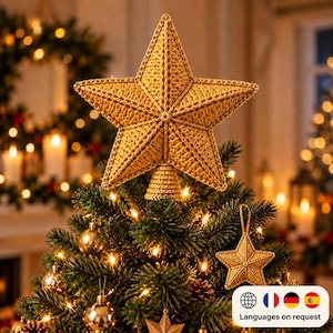 May include: A golden yellow crocheted five-pointed star tree topper with a conical base, positioned at the peak of a green pine tree. The star features a textured yarn stitch pattern and is accompanied by a smaller matching star ornament.