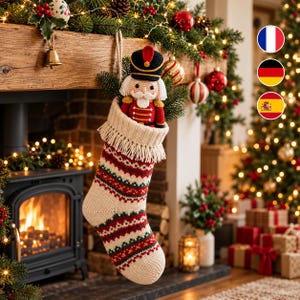 May include: A cream-colored knit Christmas stocking with red and green horizontal patterned stripes and a fringed cuff. A crocheted nutcracker doll with a black hat, red jacket, and white beard is tucked inside the stocking.