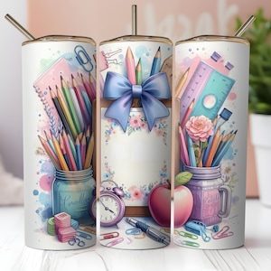 May include: A white tumbler with a gold lid and straw, featuring a watercolor design of school supplies. The design includes pencils, a ruler, an apple, and a blue bow. The tumbler is decorated with a jar of pencils and a pink flower.