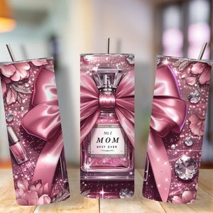 May include: A pink tumbler with a decorative design. The design includes a perfume bottle with a large bow, floral accents, and the text "No. 1 MOM BEST EVER". The tumbler has a straw.
