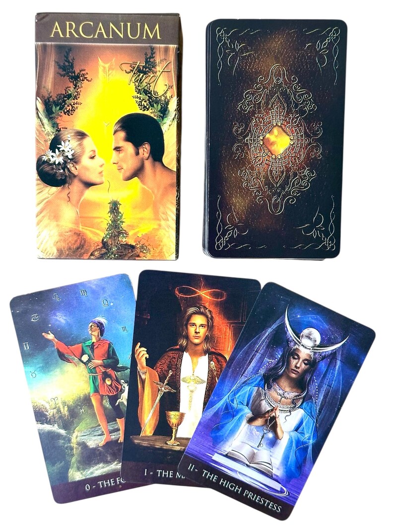 May include: A tarot card deck with the word "ARCANUM" on the box. The box features a couple in a romantic embrace. Three tarot cards are displayed, including "The Fool" and "The High Priestess". The card backs have an ornate design.