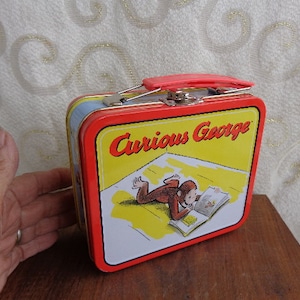 CURIOUS GEORGE 1998 LUNCHBOX - 4 3/4"H x 5 1/2"W x 2 1/4" D - Margaret Rey Artist  1996 Curious George Mini Lunchbox - Red Plastic Handle