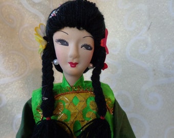 VINTAGE 15" ASIAN DOLL - Dressed in Satin Doll with yarn hair accented by flowers - Fabric Face, Hands, Body on Wood Base