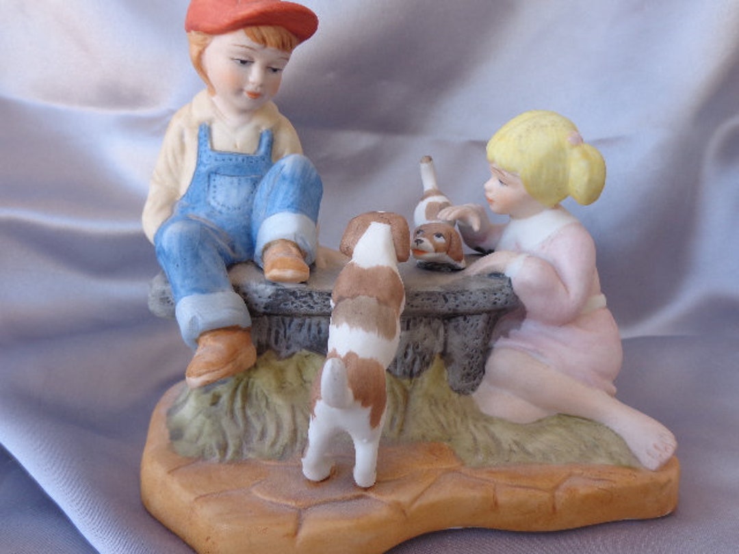 PAUL SEBASTIAN FIGURINE 1991 5 1/2 X 3 1/4 X 5 1/4 Boy and Girl With Puppies Porcelain Bisque