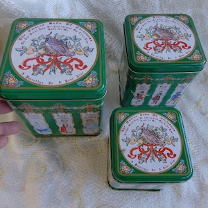 TIN CHRISTMAS TRIO - 51/4&quot; X 4 1/2&quot; X 4 1/2&quot;   4 1/2&quot; X 4&#39; X 4&quot;    4&quot; X 3 1/4&quot; X 3 1/4&quot; - 3 Pc Christmas Good Company Tin Set