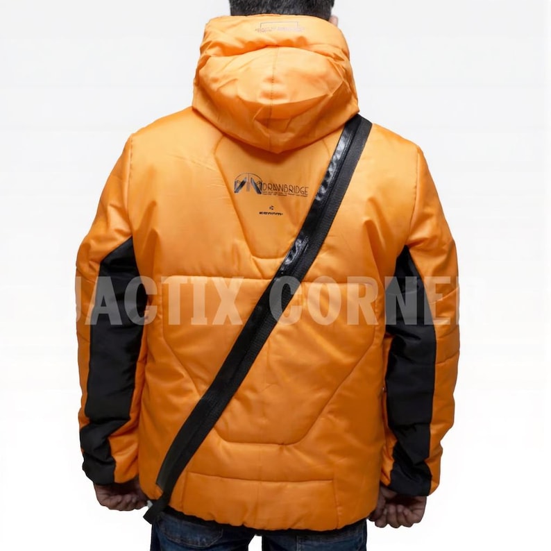 May include: Orange puffer jacket with black accents on the sleeves and a black strap across the back. The jacket has a hood and the text "ACTIX CORNER" is printed on the lower front. The jacket also has the text "DOWNBRIDGE" printed on the upper back.
