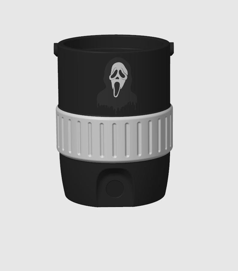 May include: Black tumbler with a white and gray Scream mask graphic. The tumbler has a white band around the middle and a black base. The tumbler has a handle on each side.