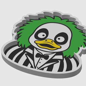 May include: A three-dimensional cookie cutter shaped like a duck with wild green hair, large eyes, a yellow beak, and a black and white striped suit with a bow tie. The object has a thick grey border and a raised design for creating detailed impressions.