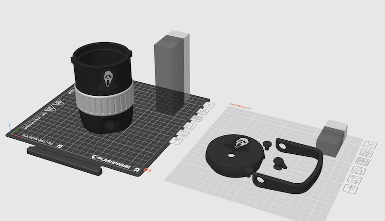 May include: A black and white tumbler with a Ghostface design, a white band, and a black handle. The tumbler is on a black Flashforge surface, with other 3D printed parts.