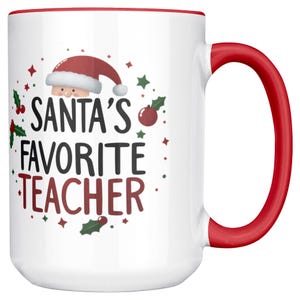 May include: White ceramic mug with a red handle and rim. The mug features the text "Santa's Favorite Teacher" in black and red, along with a Santa hat and festive holiday accents. A perfect gift for teachers.