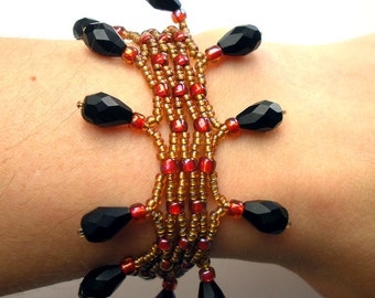 Lacey Handmade Woven Bracelet with Gold Crimson Seed Beads Black Glass Drops and Gold Leaf Toggle