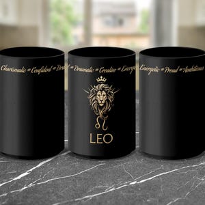 May include: Black ceramic mug with a gold lion design and the text "Leo" and "Charismatic # Confident # Dramatic # Creative # Energetic # Proud # Ambitious".