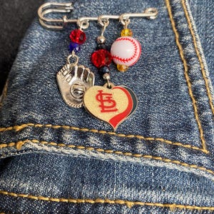 St. Louis Cardinals Silver Safety Pin with Cardinals Logo, Red and White Baseball and Baseball Glove Charm, plus Beads in Team Colors.