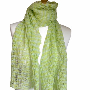May include: A light green and white striped crocheted scarf with a delicate openwork pattern.