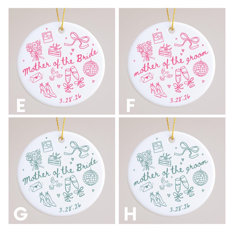 May include: White ceramic ornament with gold string, featuring pink or green illustrations and text. The text reads "Mother of the Bride" or "Mother of the Groom" with wedding-themed icons and the date "3.28.26".