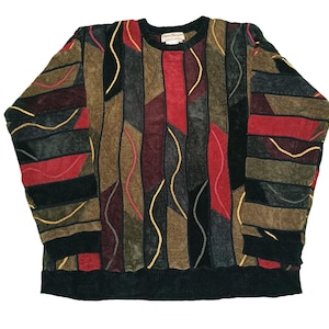 May include: A long-sleeved sweater with a patchwork design. The sweater features vertical panels in shades of red, brown, black, and gray, with wavy yellow stitching. The collar and cuffs are black. The label reads "Sergio Tacchini".