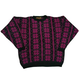 May include: A black and magenta patterned sweater. The sweater features a repeating snowflake design in magenta against a black background. The sleeves are long and the neckline is crew. The sweater is made of a knitted material.