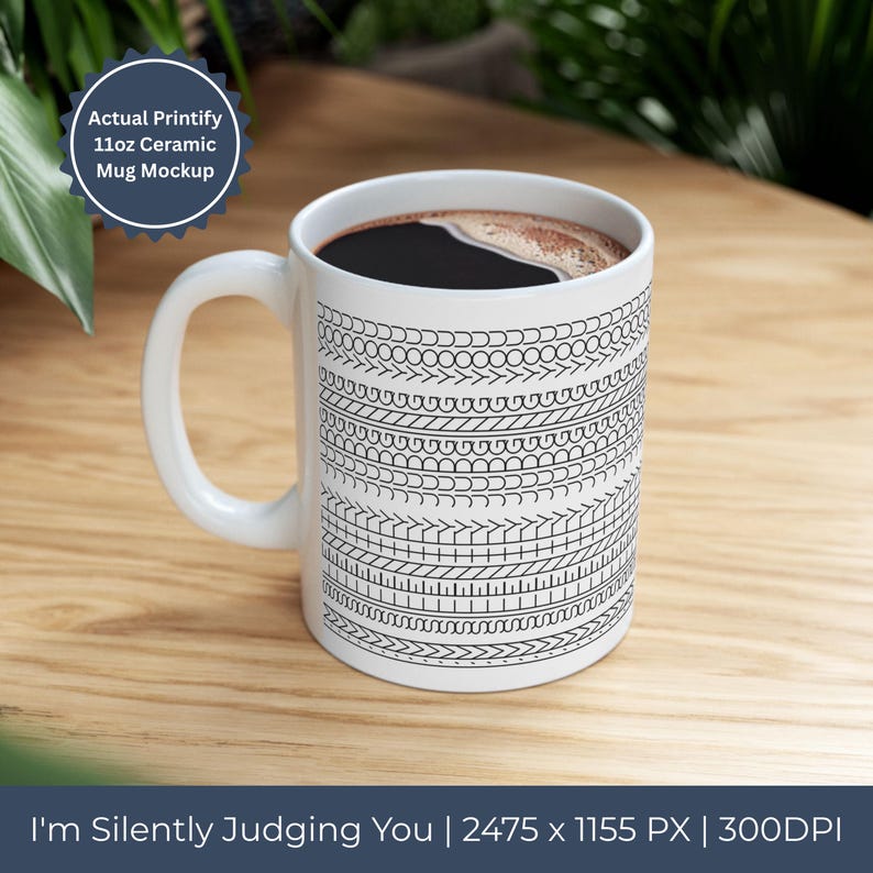 Op de afbeelding: Witte keramische mok met een zwart-wit geometrisch patroon en een gebogen handvat. De mok is gevuld met donkere koffie. De tekst "I'm Silently Judging You" staat onderaan de afbeelding.
